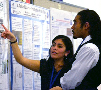 Mentor with student looking at poster