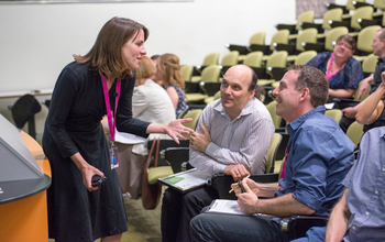 Michelle Smith talking with people in a lecture hall