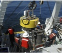 men on research vessel working with a floatation buoy