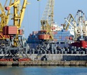 Image of cranes and conatiners in a port