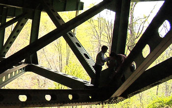 Two people working on a bridge