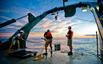 Scientists retrieving a CTD rosette from the ocean