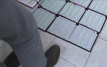 man walking on panels on sidewalk