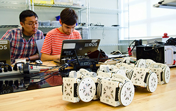 two scientists working on modular robots