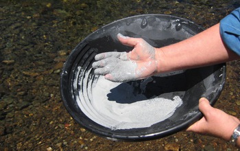 hands holding a pot with natural clay