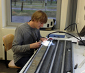 Geochemist Gabe Bowen working on a sediment core in the lab.