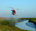 Helicopter spraying herbicide to eradicate invasive Spartina in San Francisco Bay.