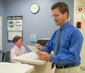 Two men and a woman in a medical office