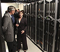 Photo of LANL Director Charles McMillan and UNM's Susan Atlas standing next to computers.