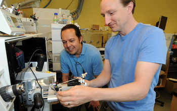 Scientists Mak Saito and Matthew McIlvin using a machine to separate individual proteins