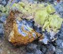 Nodule of Oregon blue clay, coated with red clay and sulfur crystals encased in white clay.