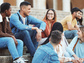 Diverse students gather on campus steps.