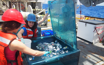 Researchers place sampling bottles in a container that mimicks the sea's light and temperature.