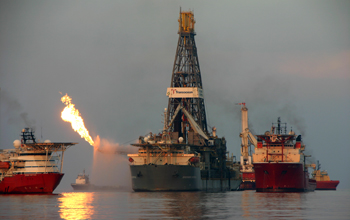 Natural gas collected from the sea floor is flared at the surface by a drillship