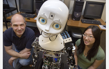 Researchers pose with the robot Nexi