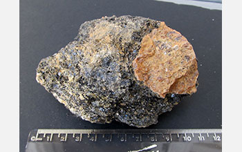 Yellow-orange phosphate mineral Wagnerite in a matrix of biotite mica and other minerals
