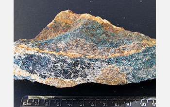 Blue prisms of borosilicate grandidierite in gneiss with aluminosilicate sillimanite and tourmaline