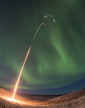 a rocket being launched into the northern lights