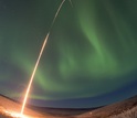 a rocket being launched into the northern lights