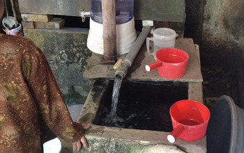 person next to a water well