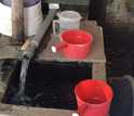 person next to a water well