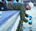 A student collecting a water sample