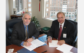 Photo of Tim Killeen of NSF and Rick Fritz of AAPG signing new agreement.