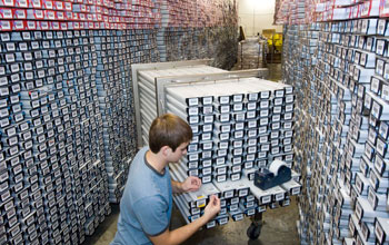 Photo of a researcher in a core repository where cores are stored.