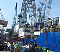 Photo of ocean drilling ship loading or unloading cargo.