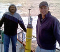 Photo of Ken Johnson and another scientist with an Apex float going for a test dive in Monterey Bay.