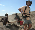 Photo of field crew sieving for fossils with geologist Jonathan Wynn.