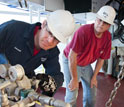 Photo of scientists pre-testing equipment before a vertical seismic profiling experiment.