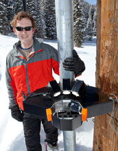 Photo of atmospheric scientist Tim Garrett using instruments to study snow.