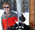 Photo of atmospheric scientist Tim Garrett using instruments to study snow.