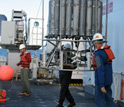 Photo showing deployment of an instrument to sample seawater at different depths.