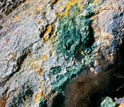 Yellow sulfur deposits and green Galdieria alga on a rock