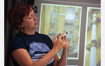 Beth Orcutt discusses CORK microbiology experiments with colleagues during the expedition.