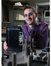Grad student in laboratory with his laptop-size invention, the Mini-Z