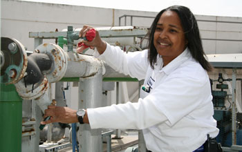 Photo of a woman holding a red rag with her other hand on a handle.