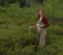 Jennie Sirota conducting research within the confines of a dark bog.