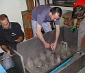 Research team members carefully craft the centrifuge sample chamber that holds the experiment.