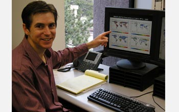 Photo of Peter Lawrence pointing to landcover changes on a computer screen.