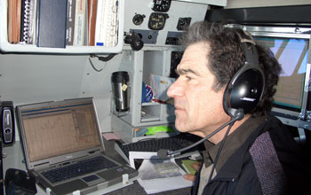 Photo of lead researcher Andrew Heymsfield monitoring clouds from an aircraft.