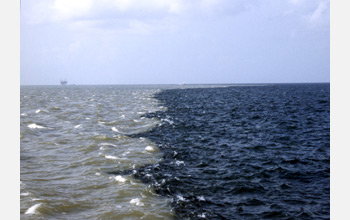 Photo of the sediment laden Mississippi River on left and Gulf of Mexico on the right.