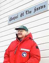 Rev. John Coleman in front of sign, Chapel Of The Snows.