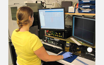 Photo of a researcher at Harvard University working on a problem at a computer terminal in a lab.