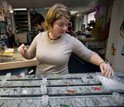 Aboard the JOIDES Resolution, Stacie Blair collects sediment samples from a core.