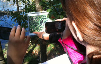 A student using a visual target to see a 3-D image on the mobile device.