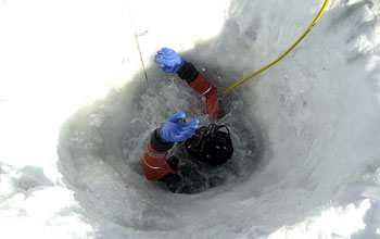 Diver begins his descent into the frigid waters of McMurdo Sound, Antarctica