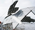 Photo of a crane removing a section of the geodesic dome at Amundsen-Scott South Pole Station.